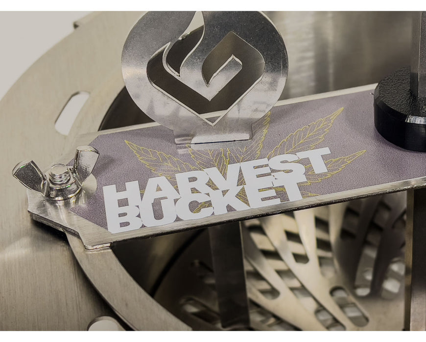 Close-up of the GreenBroz Harvest Bucket Trimmer logo plate mounted on the trimming assembly.