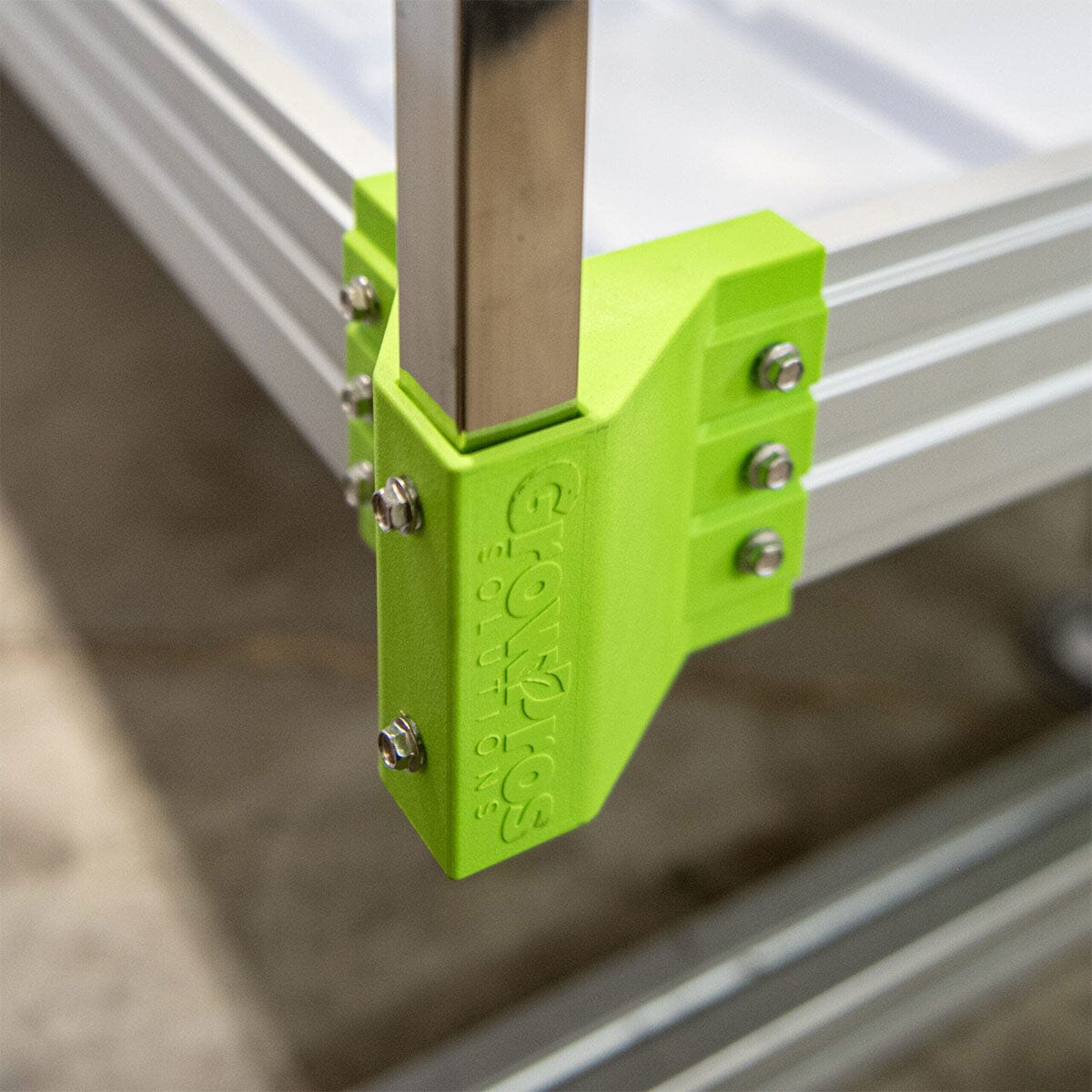Close-up of bright green corner bracket with embossed GrowPros logo, ensuring secure frame joints.