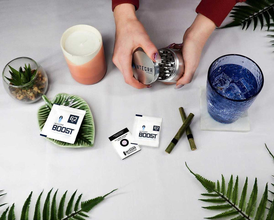 Integra BOOST 8g 62% RH shown in tabletop setup with grinder, drinks, and other tools.