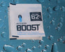 Integra BOOST 8g 62% RH on blue background with water droplets for moisture control visuals.