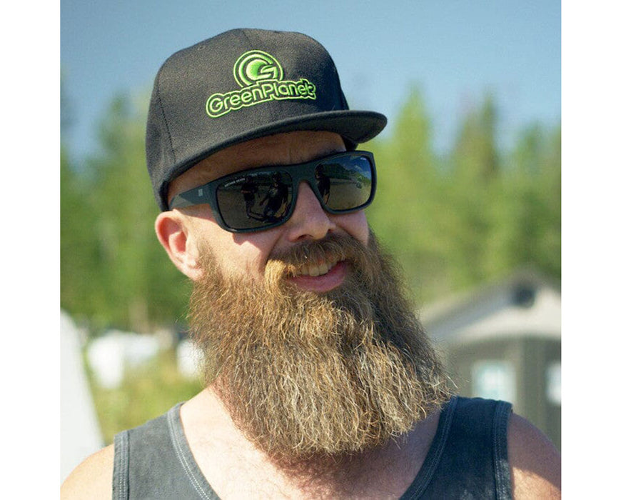 Man outdoors wearing Citadel Sun Polarized sunglasses and GreenPlanet hat.