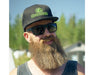 Man outdoors wearing Citadel Sun Polarized sunglasses and GreenPlanet hat.