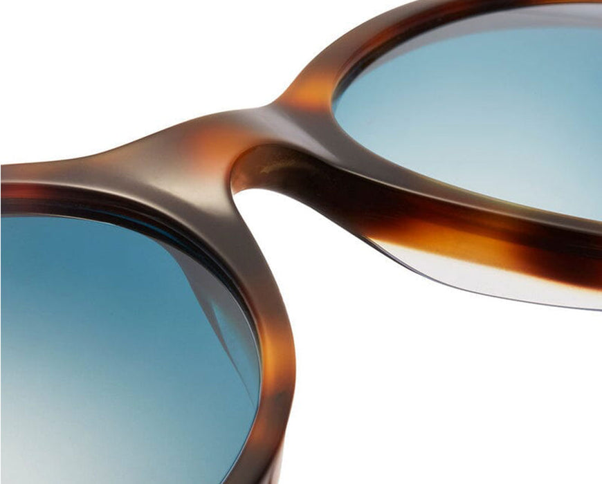 Angled view of bridge area showing lens curvature and acetate blending.