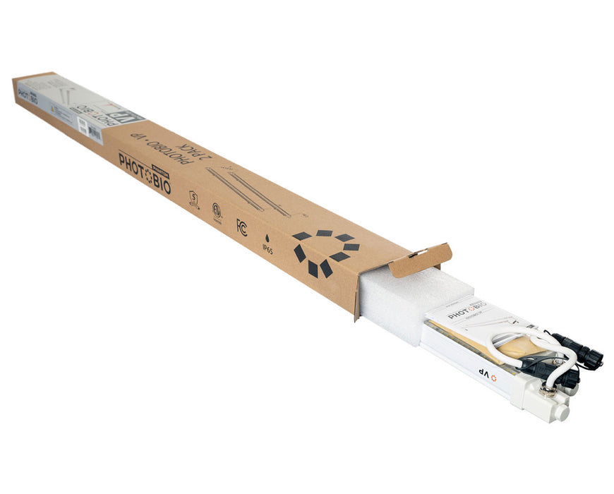 PHOTOBIO VP 32W LED grow light bars partially unpacked from branded cardboard shipping box with foam protection.