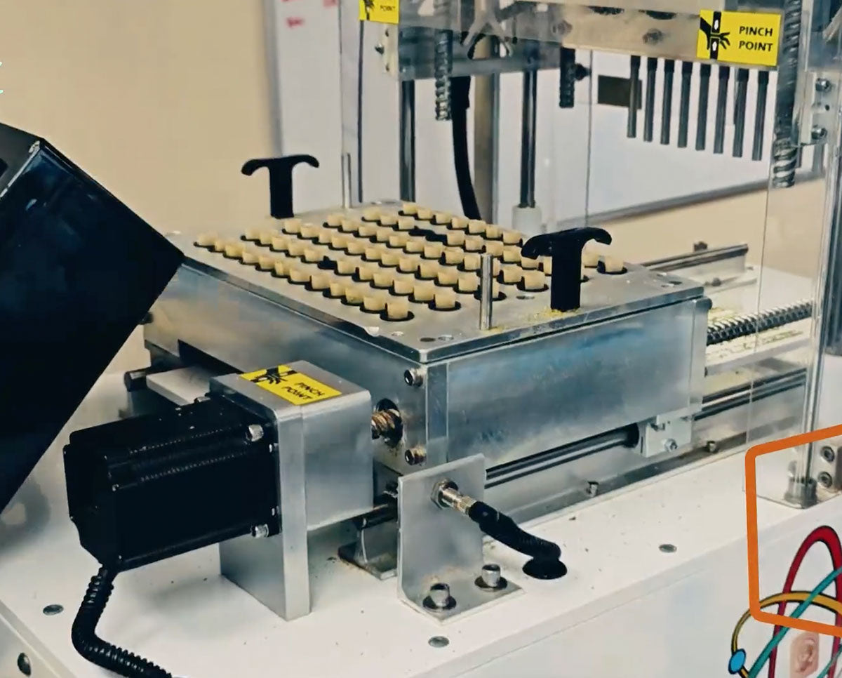 Astro Infuser bud pre-roll machine loaded with cones, designed for high-speed, precision oil or concentrate infusion.