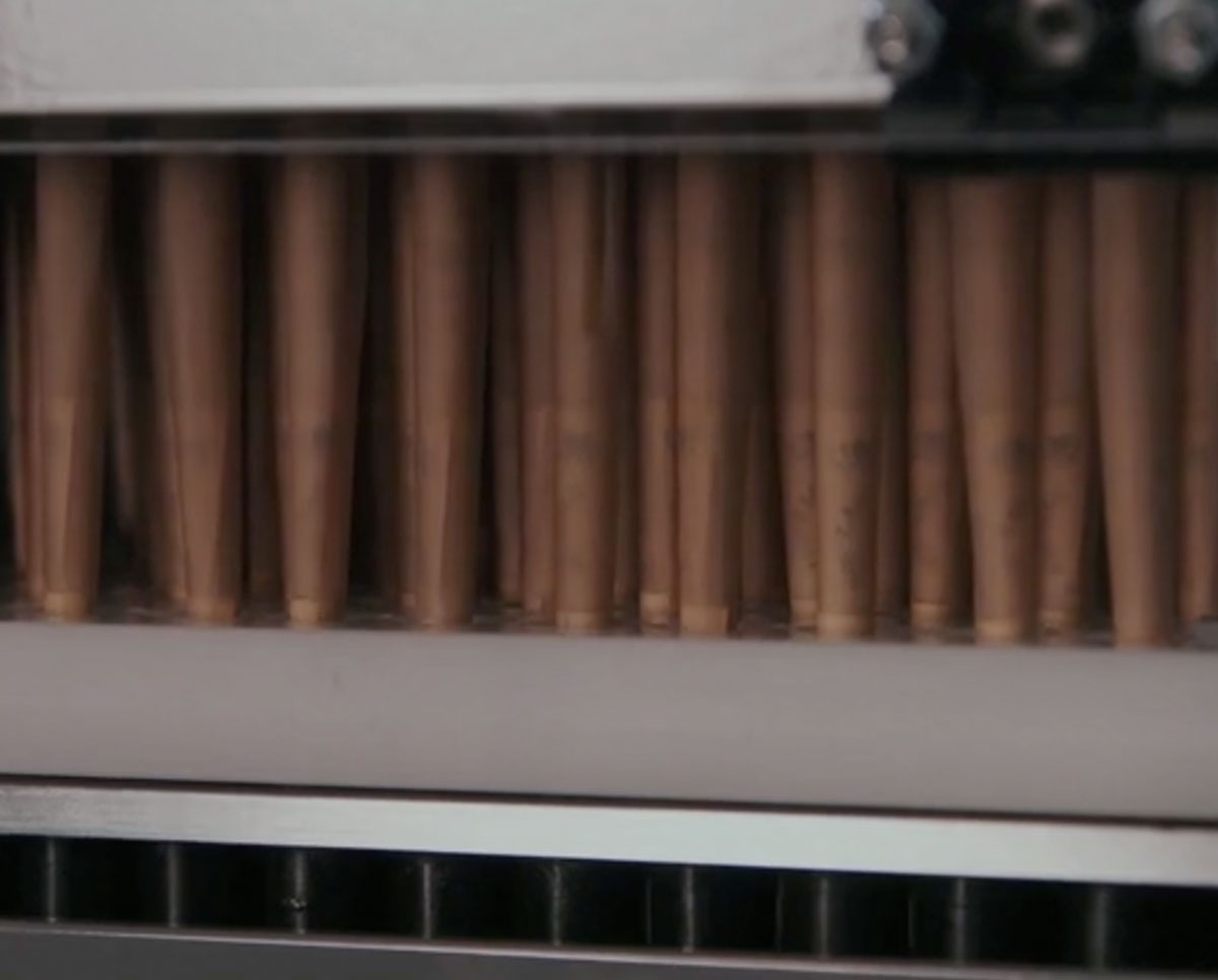 Close-up of 72 pre-roll cones neatly aligned under STM Cone Lander, ready for automated filling in high-volume production.