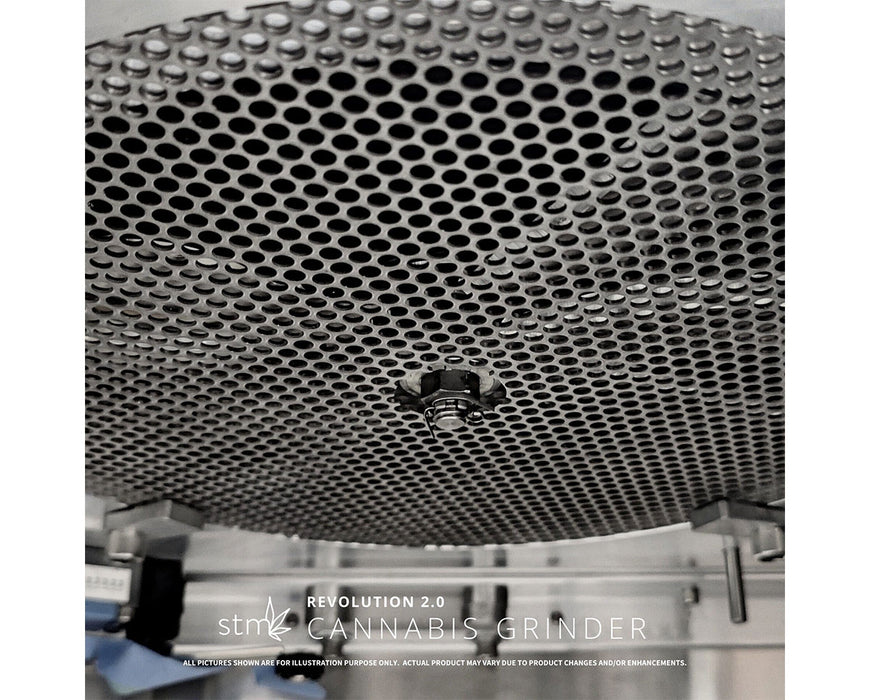 Industrial grinding screen inside STM Revolution 2.0 Grinder showing perforated metal plate.