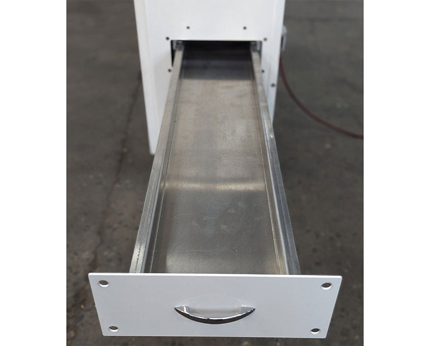 Extended internal metal drawer of the RocketBox PRO pre-roll machine used for collecting material.