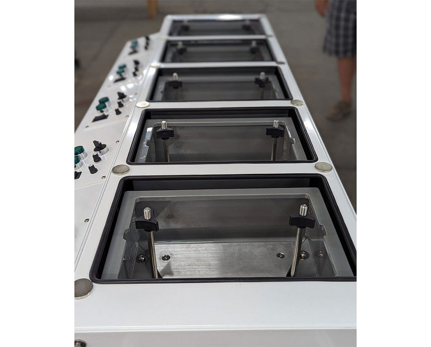 Close-up of open pre-roll trays on the RocketBox PRO machine showing adjustment knobs and tray depth.