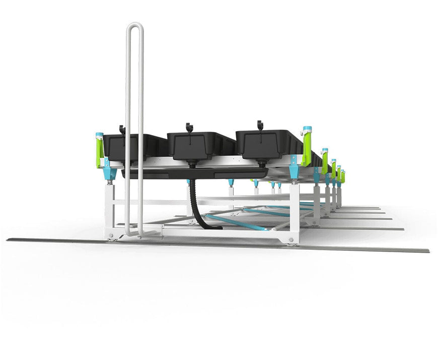 Close side view of the bench system showing grow trays, centralized drainage hose, and support frame detail.