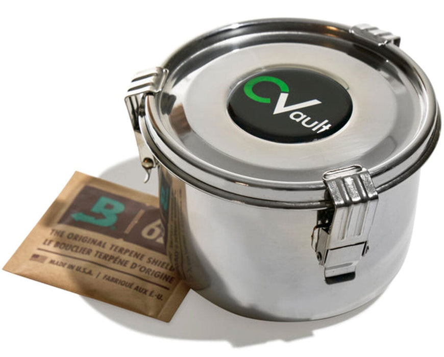 Close-up of a CVault Personal bud storage container made of stainless steel, paired with a Boveda 62% RH humidity pack, highlighting the airtight design and secure latches.