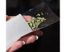 Hand holding a Dulytek nylon rosin filter bag partially filled with green plant material using the included loading card.