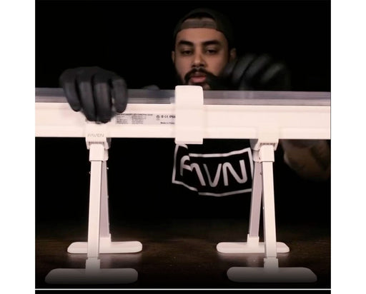 Installer using Faven couplings to secure Chroma under canopy lights onto support stands.