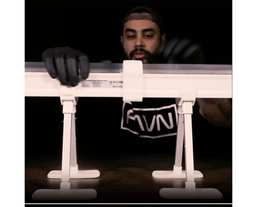 Installer using Faven couplings to secure Chroma under canopy lights onto support stands.