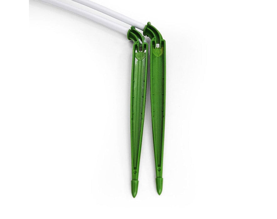 Close-up of green FloraFlex micro tube stake drippers with torturous path design for controlled flow.