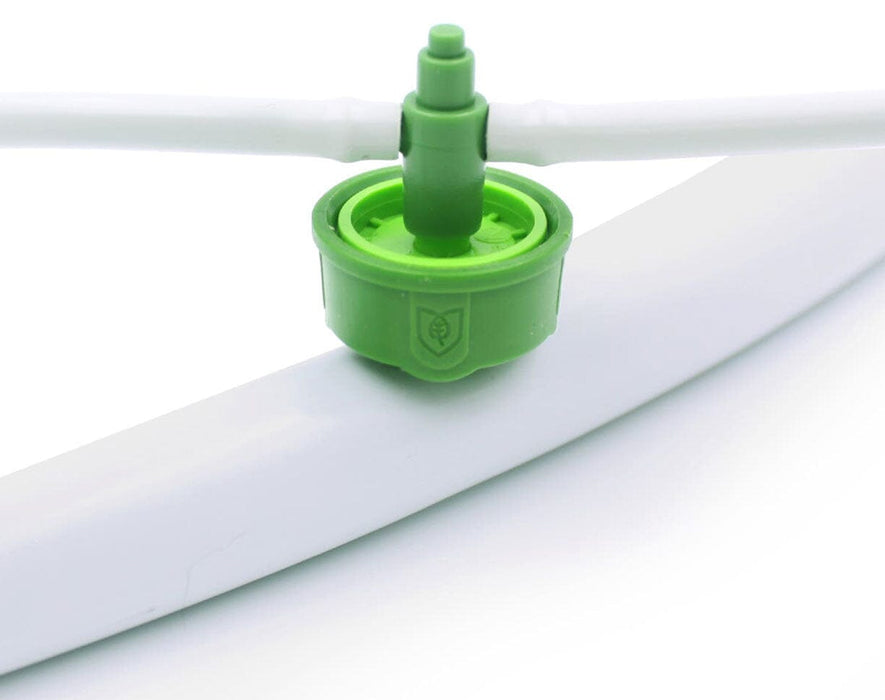 Angled view of FloraFlex emitter inserted into the white double-layer irrigation tubing.