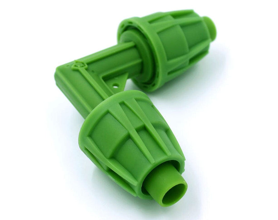 Close-up of green FloraFlex 16/17mm elbow fitting for connecting irrigation tubing at a 90-degree angle.