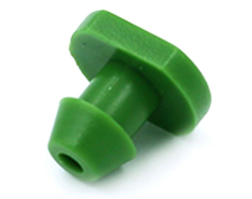 Close-up of a single green FloraFlex emitter plug for irrigation tubing hole sealing.