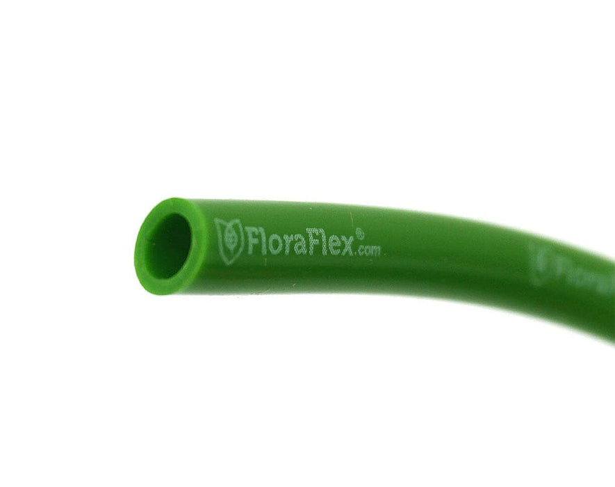 Close-up of FloraFlex 1/4" vinyl tubing showing flexible green exterior and branded print for quality assurance.