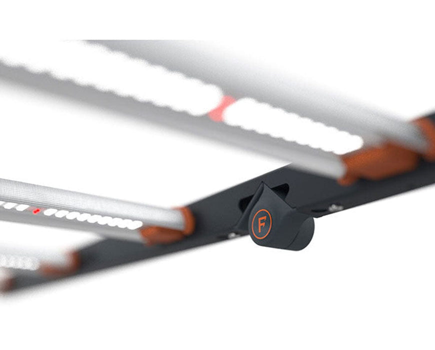 Detail of Fluence SPYDR 2r black fold lock marked with orange “F” securing aluminum light bars.