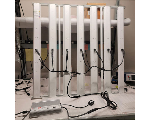 Indoor assembly of HLG Genesis X HV LED grow light with driver connected and wiring organized for testing or installation.