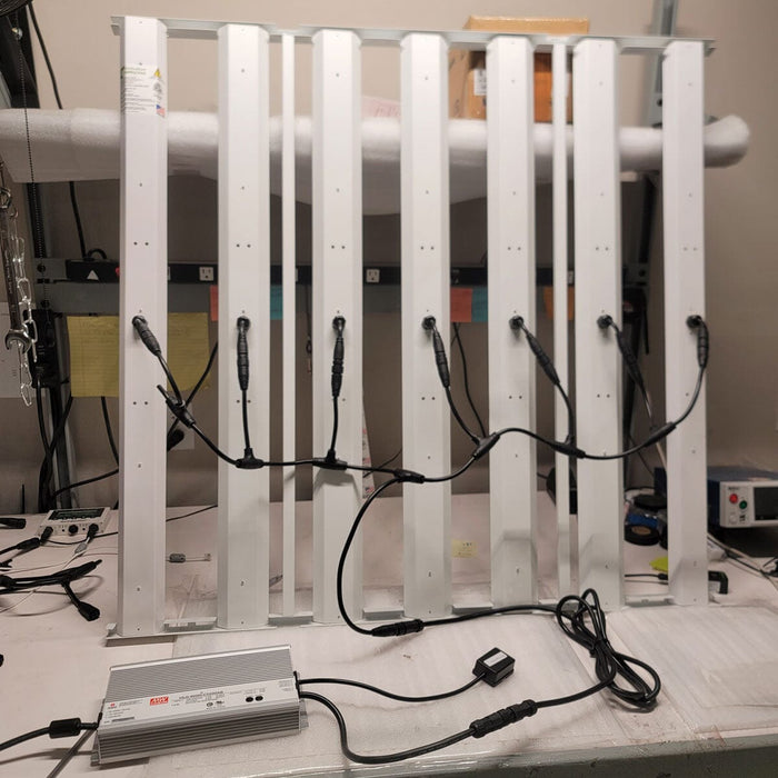 Indoor assembly of HLG Genesis X HV LED grow light with driver connected and wiring organized for testing or installation.
