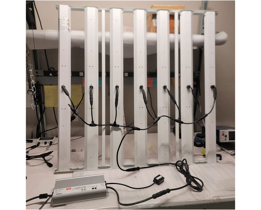 Indoor assembly of HLG Genesis X HV LED grow light with driver connected and wiring organized for testing or installation.