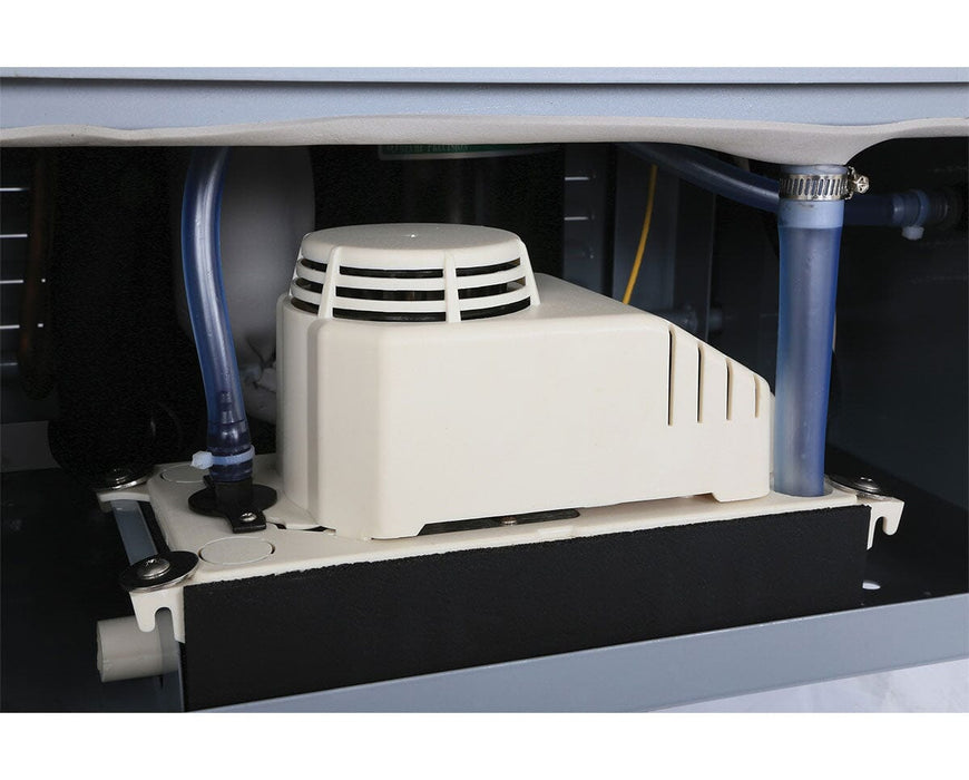 Close-up of the internal pump mechanism inside the dehumidifier, showing connected blue tubing and a white vented housing mounted on a metal bracket.