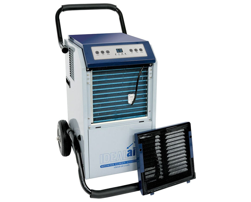 A large commercial-grade dehumidifier by Ideal-Air with the front filter panel removed, revealing the blue coil fins and internal components. The unit is mounted on wheels with a handle for mobility.