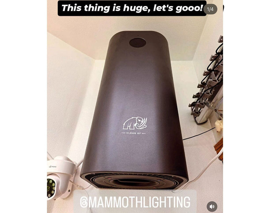 Wall-mounted Mammoth Clean AF 2nd Gen Air Sanitizer in a grow room setup, showcasing its large size and sleek black design.