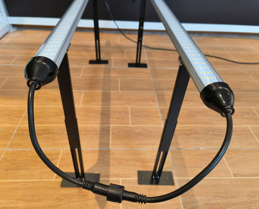 Close-up of two Mammoth Clone & Inter-Canopy bars connected and mounted on adjustable metal stands.