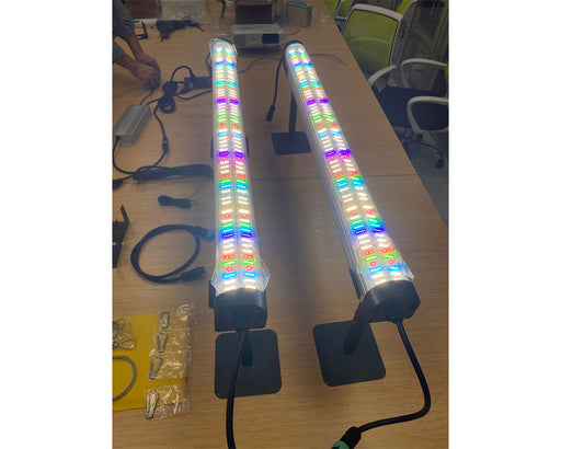 Two powered-on Nova Sun LED bars on stands displaying multicolor diode mix for full-spectrum light output.