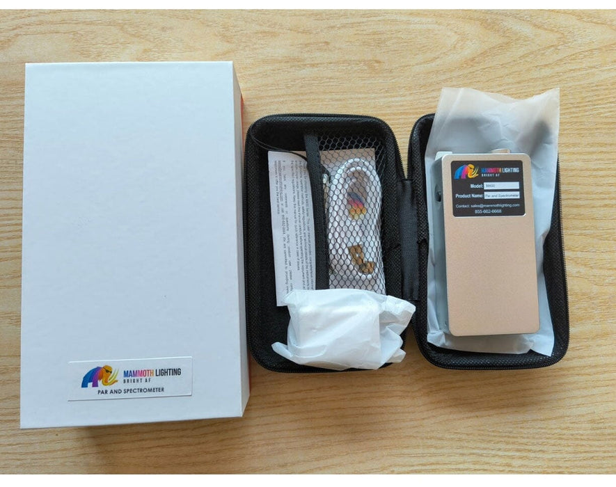 M400 spectrometer kit with carrying case, USB cable, and manual, shown on a wooden table beside white packaging box.