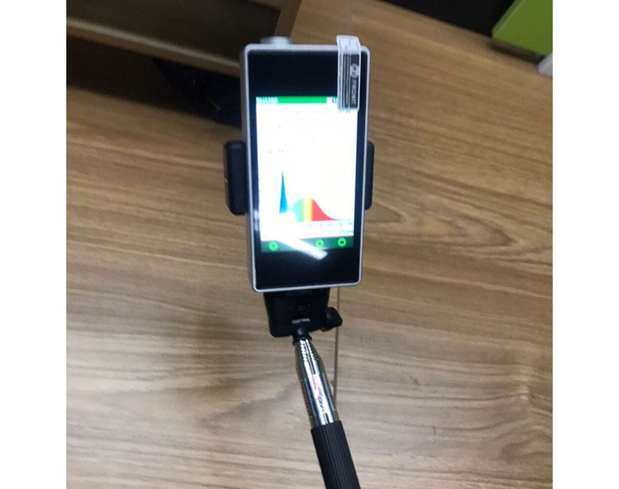 Mammoth Lighting M400 PAR Meter mounted on tripod with screen displaying full-spectrum light profile on wood floor.