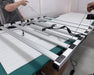 Technician assembling Mammoth Nova Sun Veg + Mom LED grow light with modular six bar folding frame.