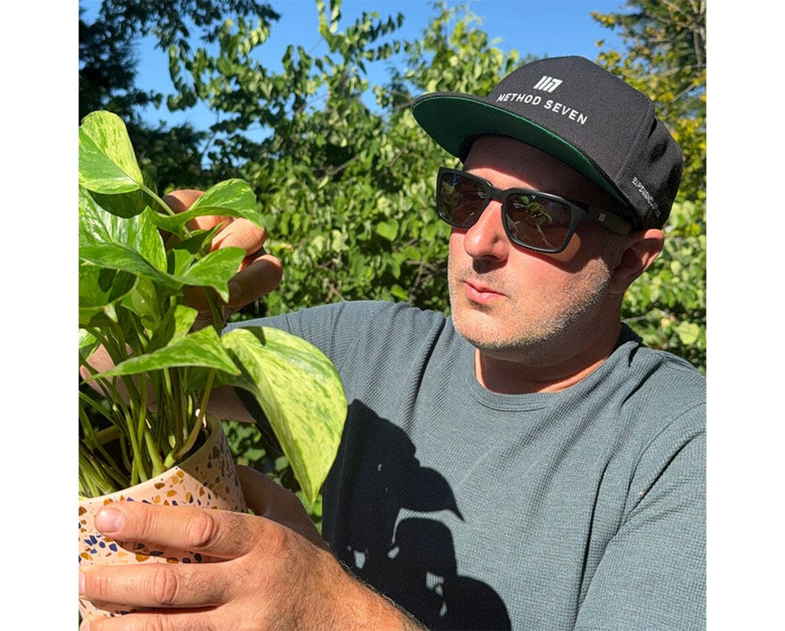 Grower wearing Method Seven Evolution FX2 LED glasses outdoors for UV protection and color correction.