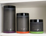 Three ONGROK frosted glass jars of varying sizes displayed side-by-side on a shelf, each with a different colored silicone base for easy identification.