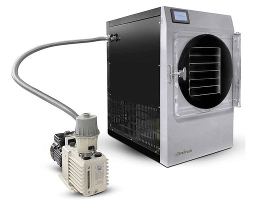 Stay Fresh Mega Freeze Dryer with clear front door, six tray shelves, and attached stainless steel vacuum pump.