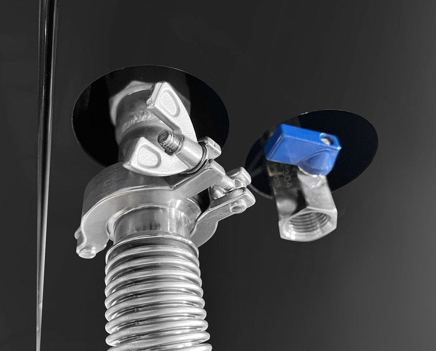 Underside view showing vacuum hose and blue valve connection points on the freeze dryer.