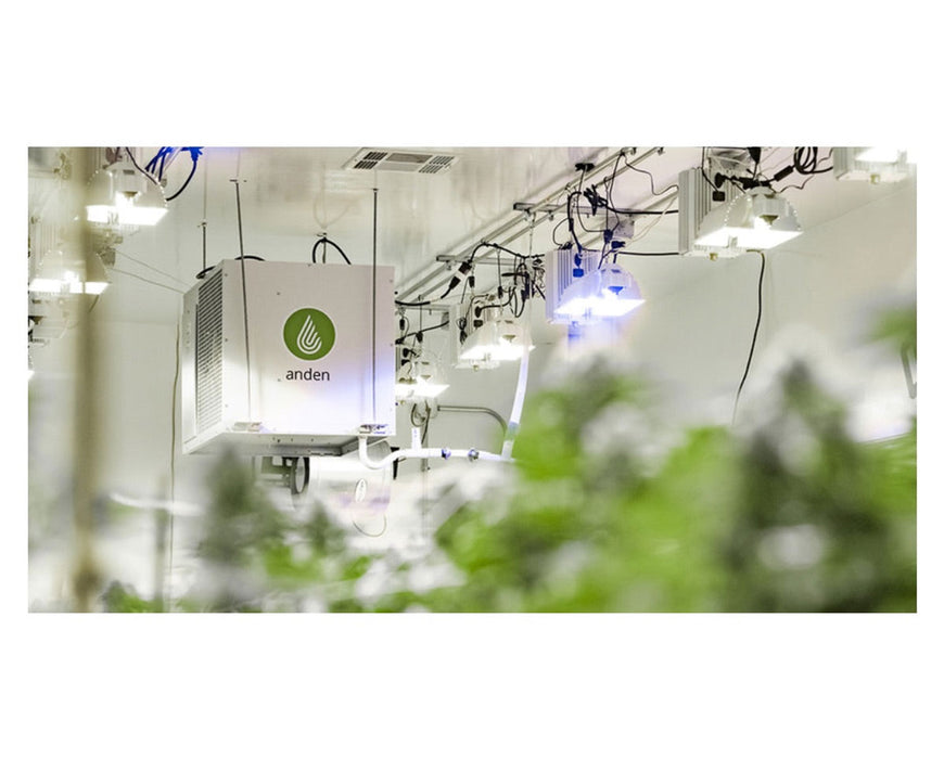 Anden 710V3 dehumidifier mounted in a grow room with lights and blurred plants in the foreground.