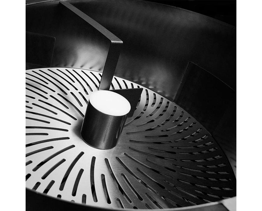 Internal view of the GreenBroz M+ trimming chamber showing precision-engineered blade slots and rotating center post.