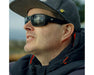 Man outdoors wearing Method Seven Resistance 2 Sun Polarized glasses, showing reflective lenses and durable frame.