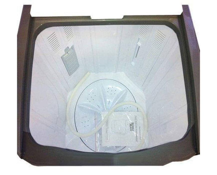 Interior of the Bubble Magic washing machine with a clear view of the agitator, included hose, and instruction manual at the bottom.