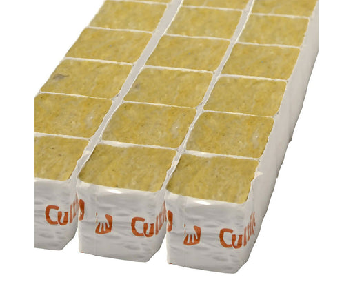 Multiple Cultiwool Mini Clone Blocks arranged in a shrink-wrapped tray, showing uniform yellow rockwool cubes encased in white printed wrap for young plant propagation.