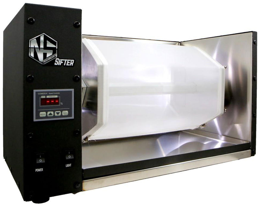 Side view of the NugSmasher Sifter showing the full hex drum, digital speed controller, and power/light switches in a clean stainless steel workspace.