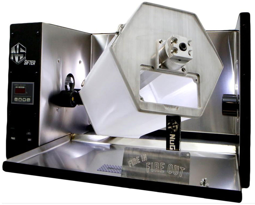 Angled view of the NugSmasher Sifter dry sift tumbler showing the open hexagonal drum with stainless steel construction and “Fire In Fire Out” plate.